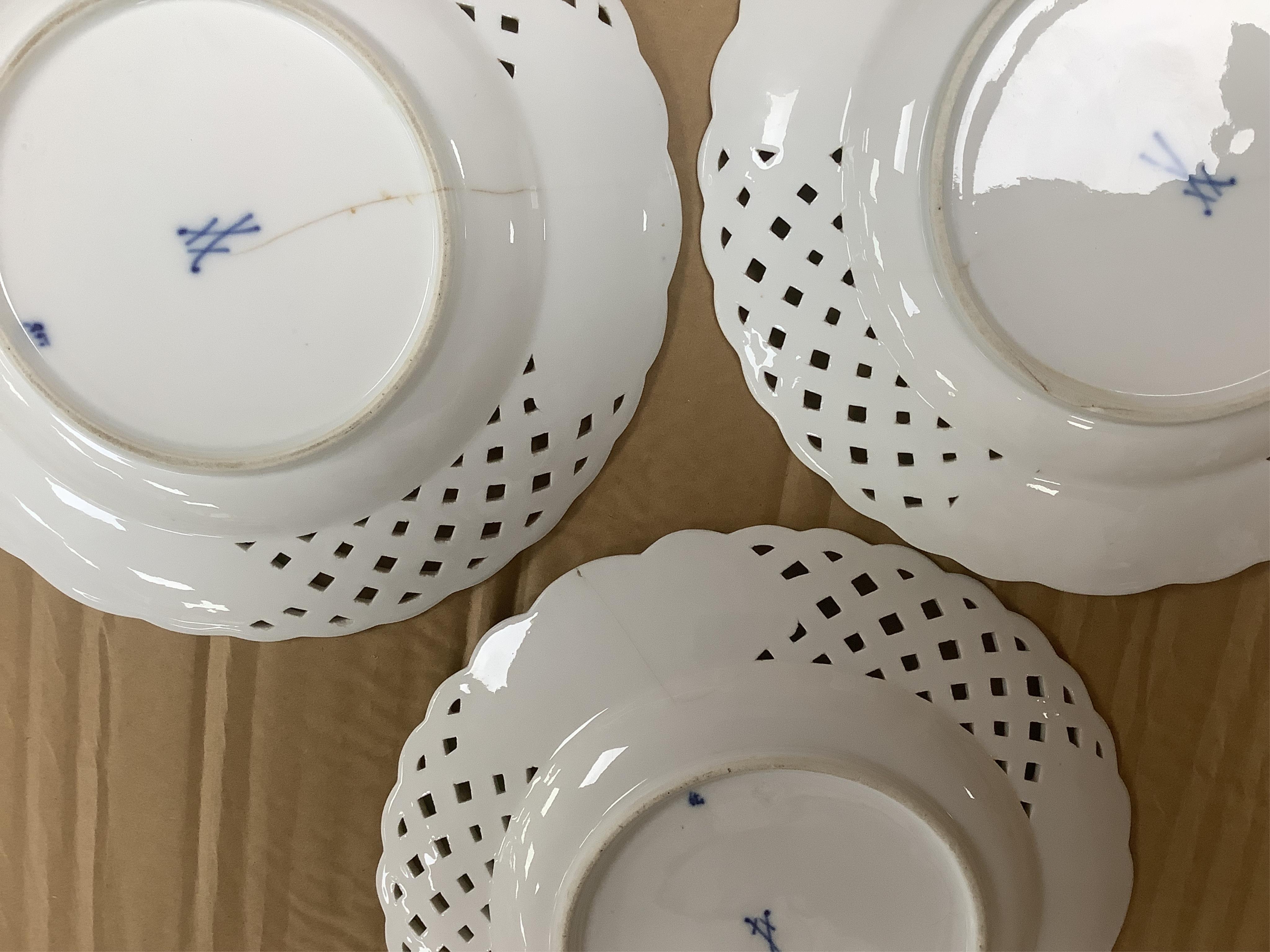 A late 19th Meissen blue and white onion pattern dessert service, consisting of a pair of comports and twelve dishes, all with pierced borders, (14). Condition - poor to good, two plates with pieces of border missing, on